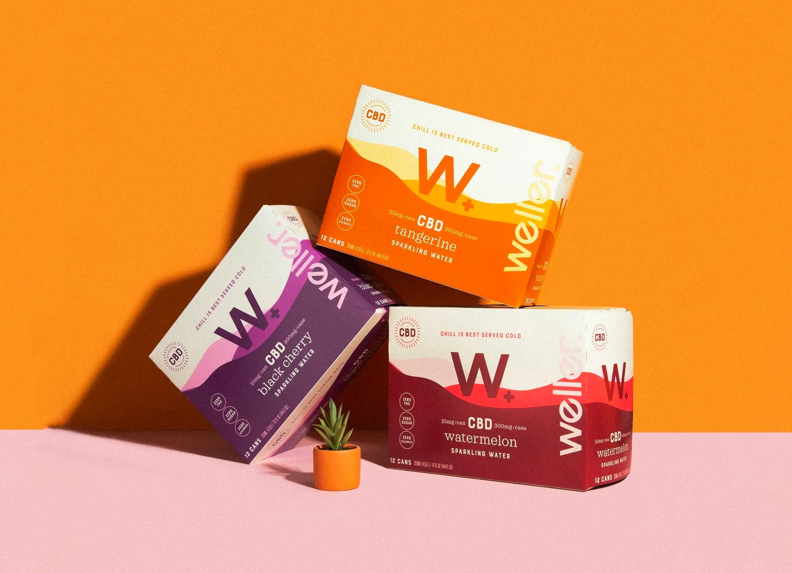 Stacked boxes of Weller CBD sparkling water in tangerine, black berry and watermelon flavors on an orange and pink backdrop