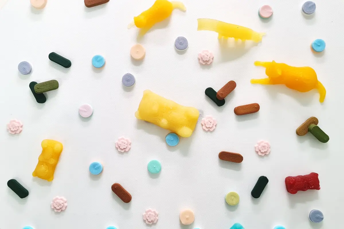 Assorted 3D-printed dosage forms: tablets, chewables and gummies