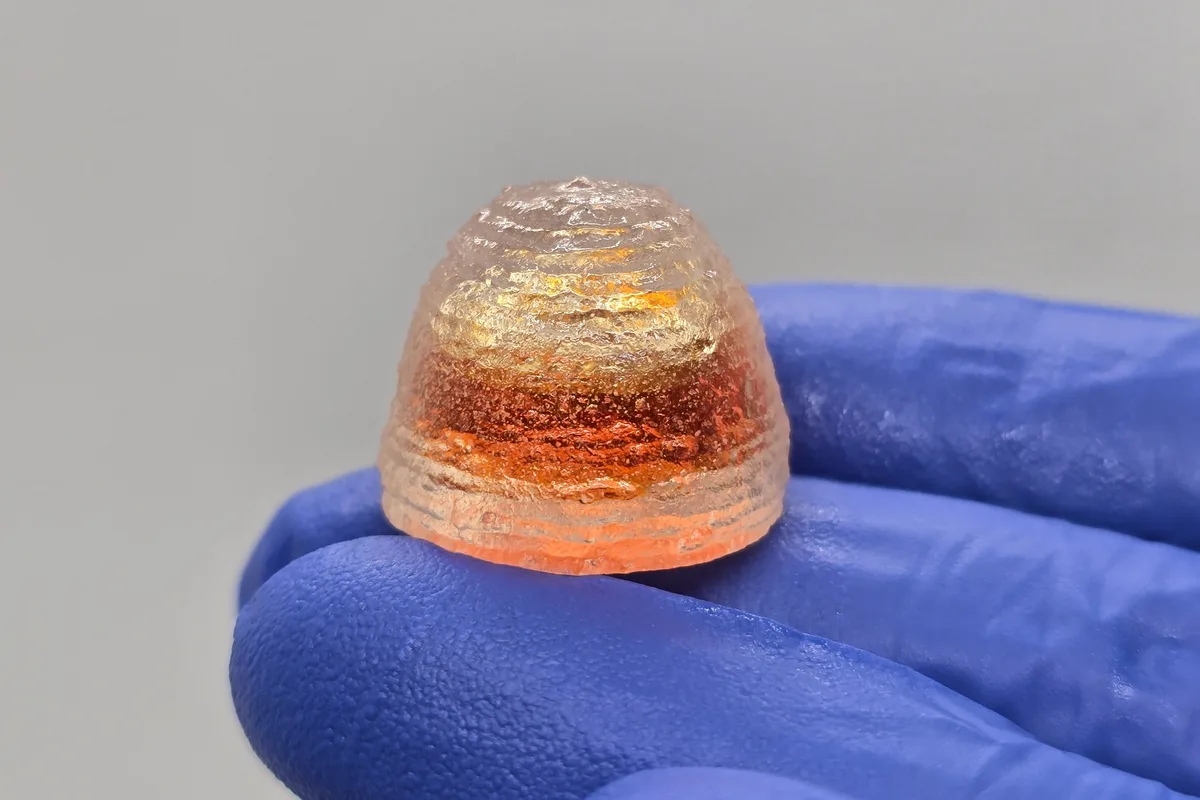Liquid-filled 3D-printed chewable held in a gloved hand