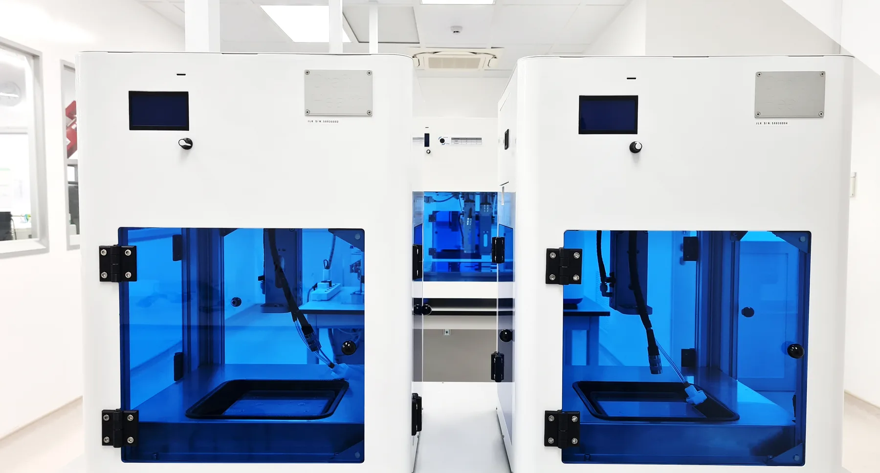 Two CraftMake pharmaceutical 3D printers in a laboratory