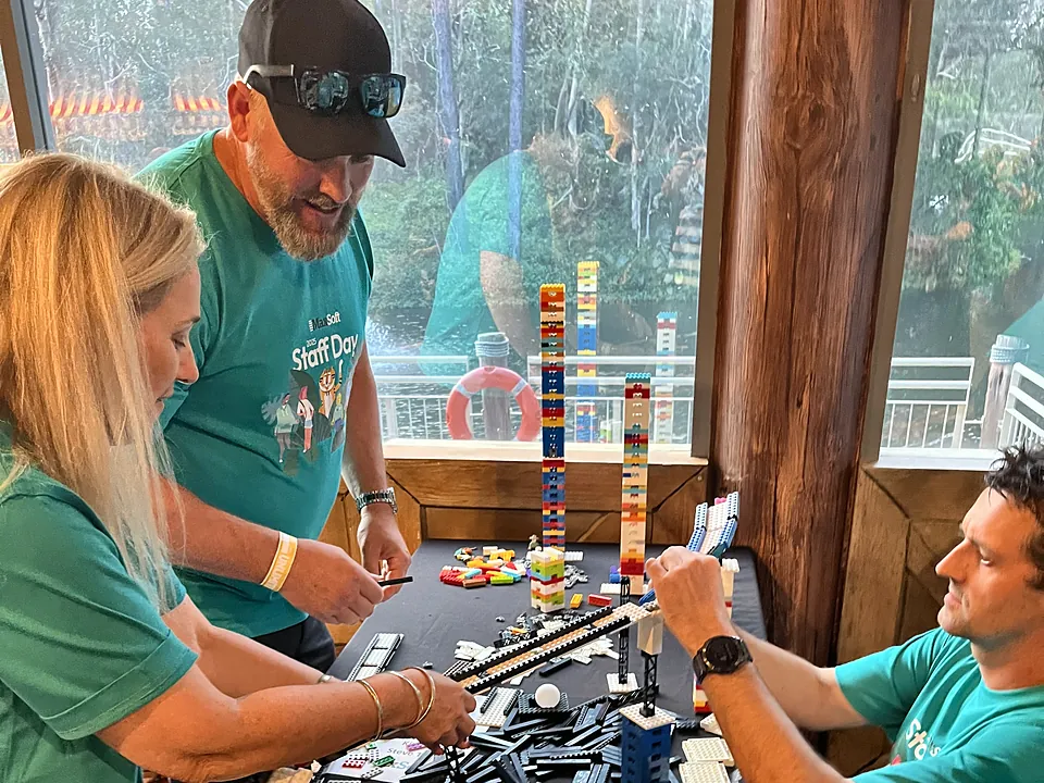 MaxSoft team building with toy bricks in a Staff Day challenge