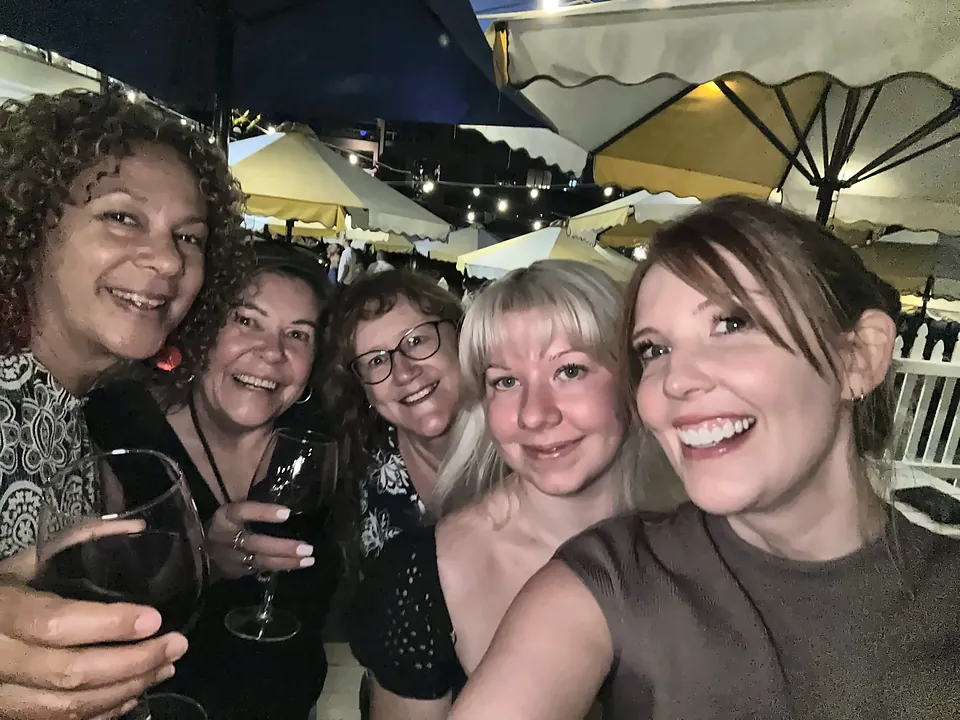 MaxSoft team members taking a selfie at an evening get-together