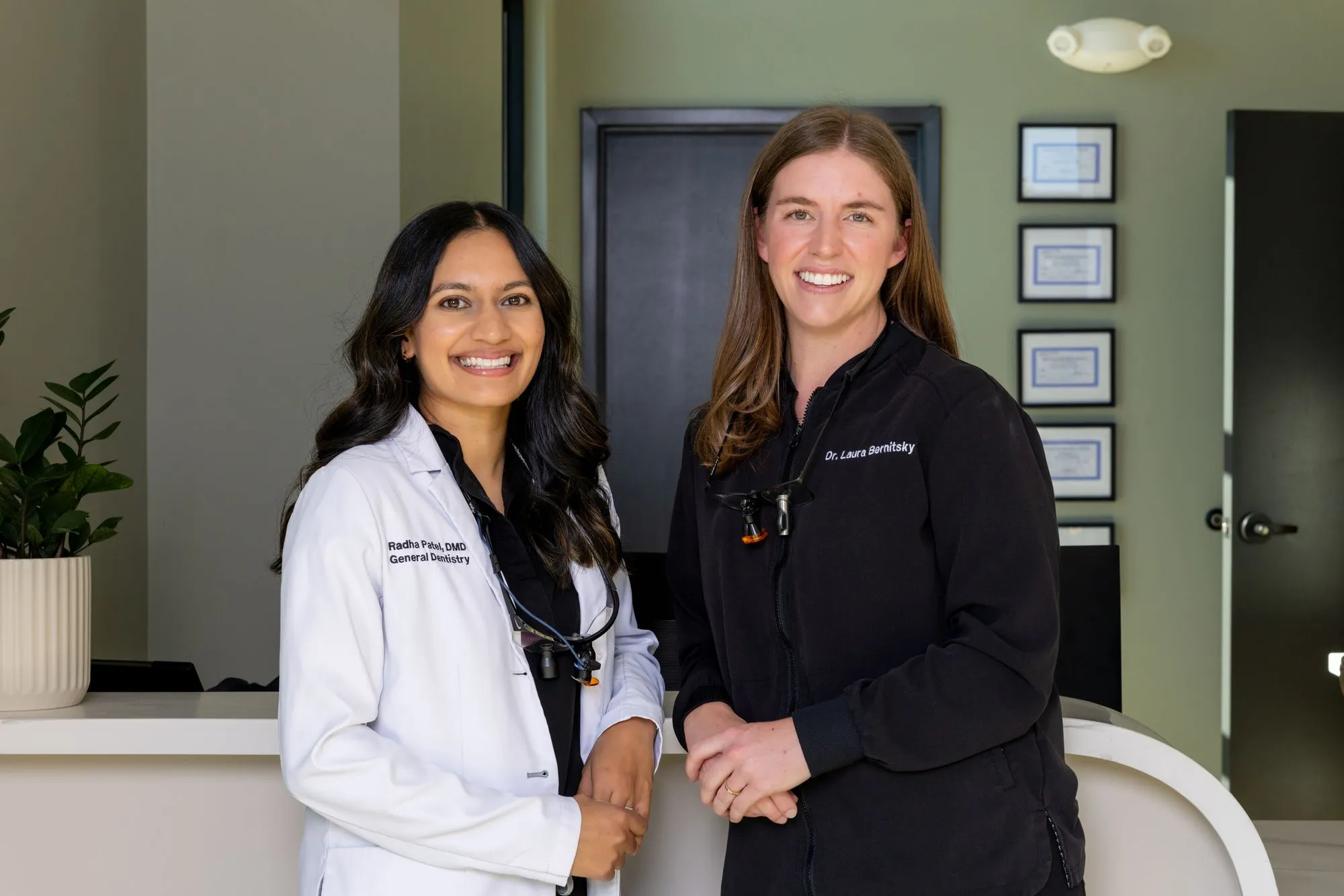 Dr. Patel and Dr. Bernitsky at the front desk of White Rose Dentistry in York, SC