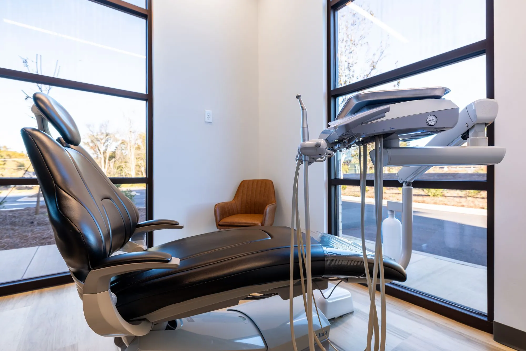 Private treatment room with large windows and a ceiling TV
