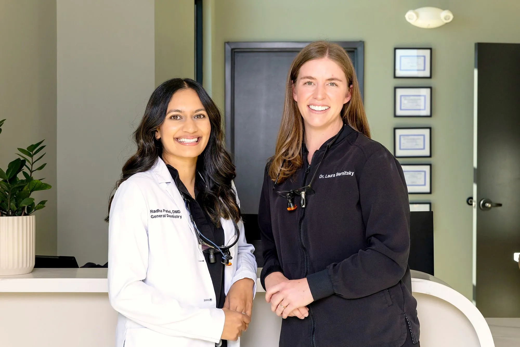 Dr. Radha Patel and Dr. Laura Bernitsky at the front desk of White Rose Dentistry in York, SC