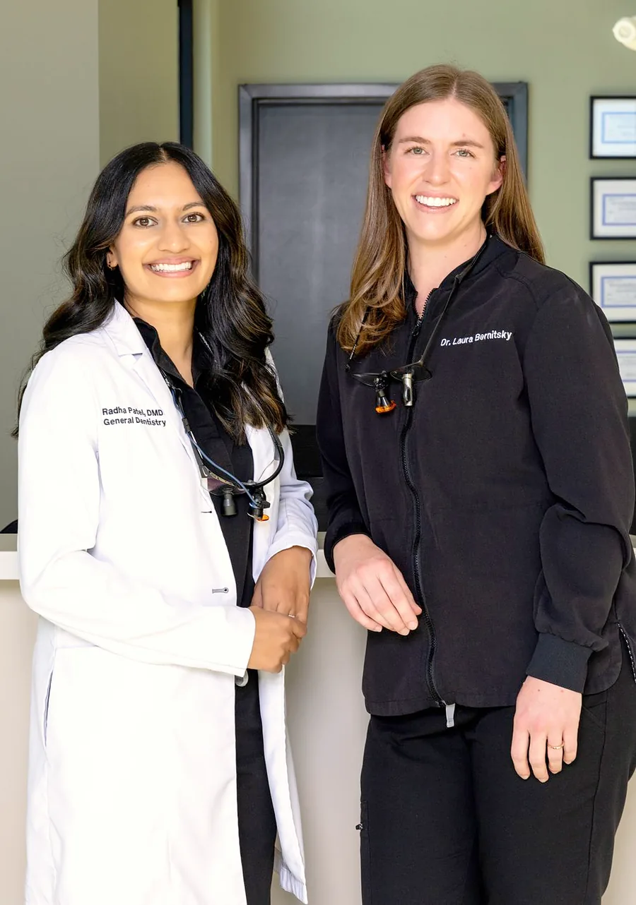 Dr. Radha Patel and Dr. Laura Bernitsky at the front desk of White Rose Dentistry in York, SC