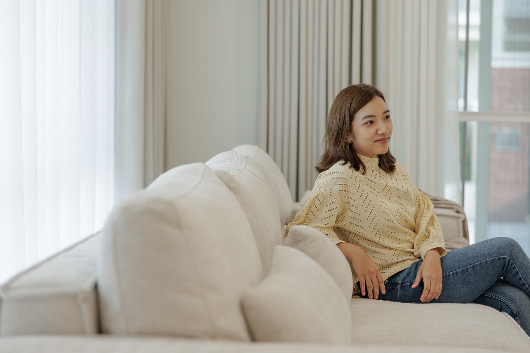 Aom smiling on the sofa at home