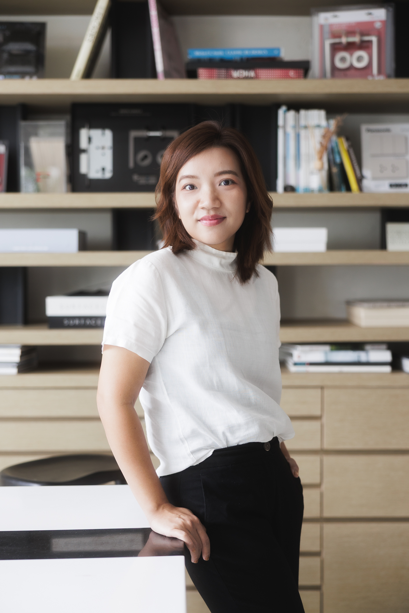 Aom smiling while reading in her studio