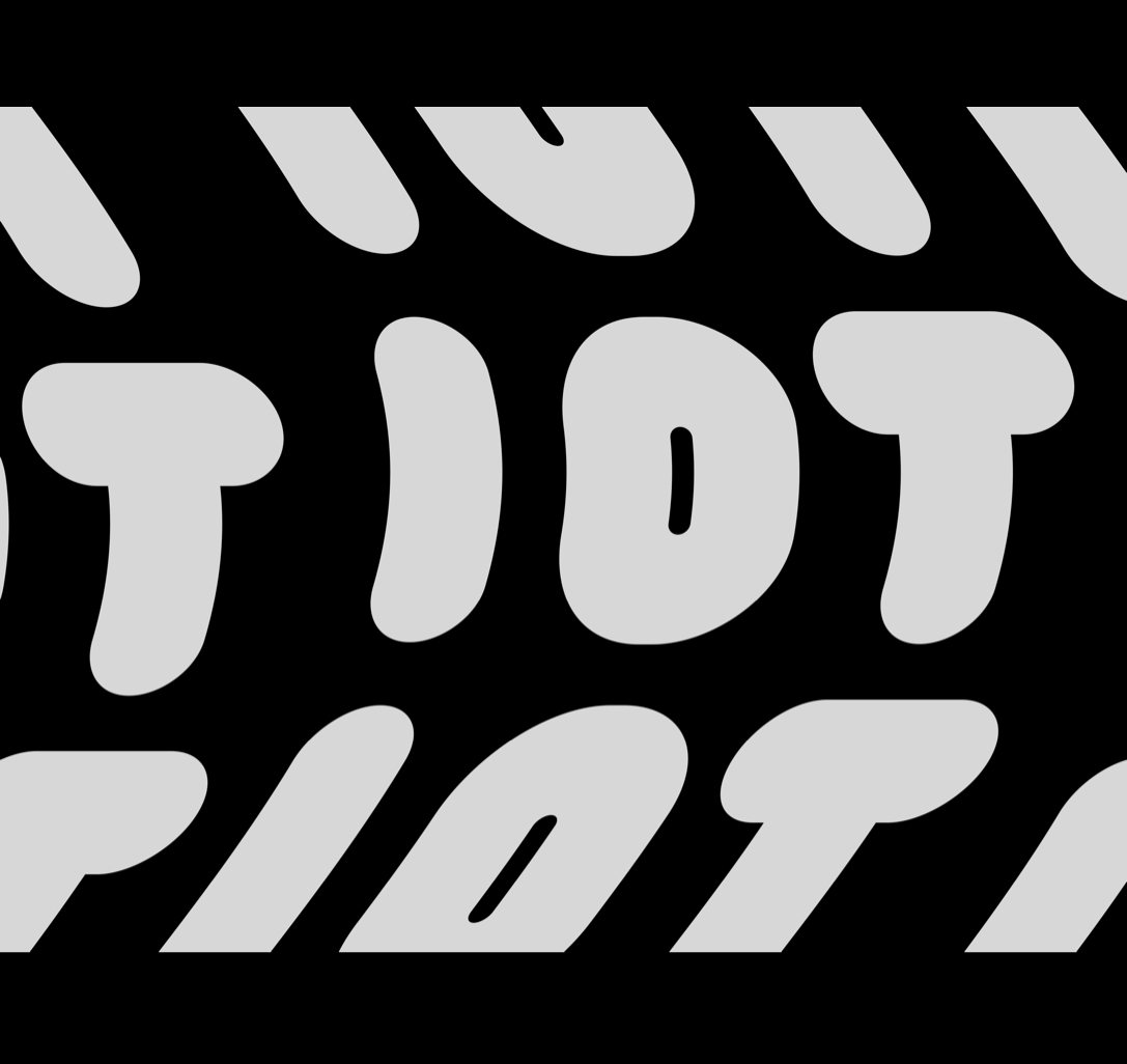 Rows of bulbous light gray letters spelling IOT, the outer rows slanted, on black