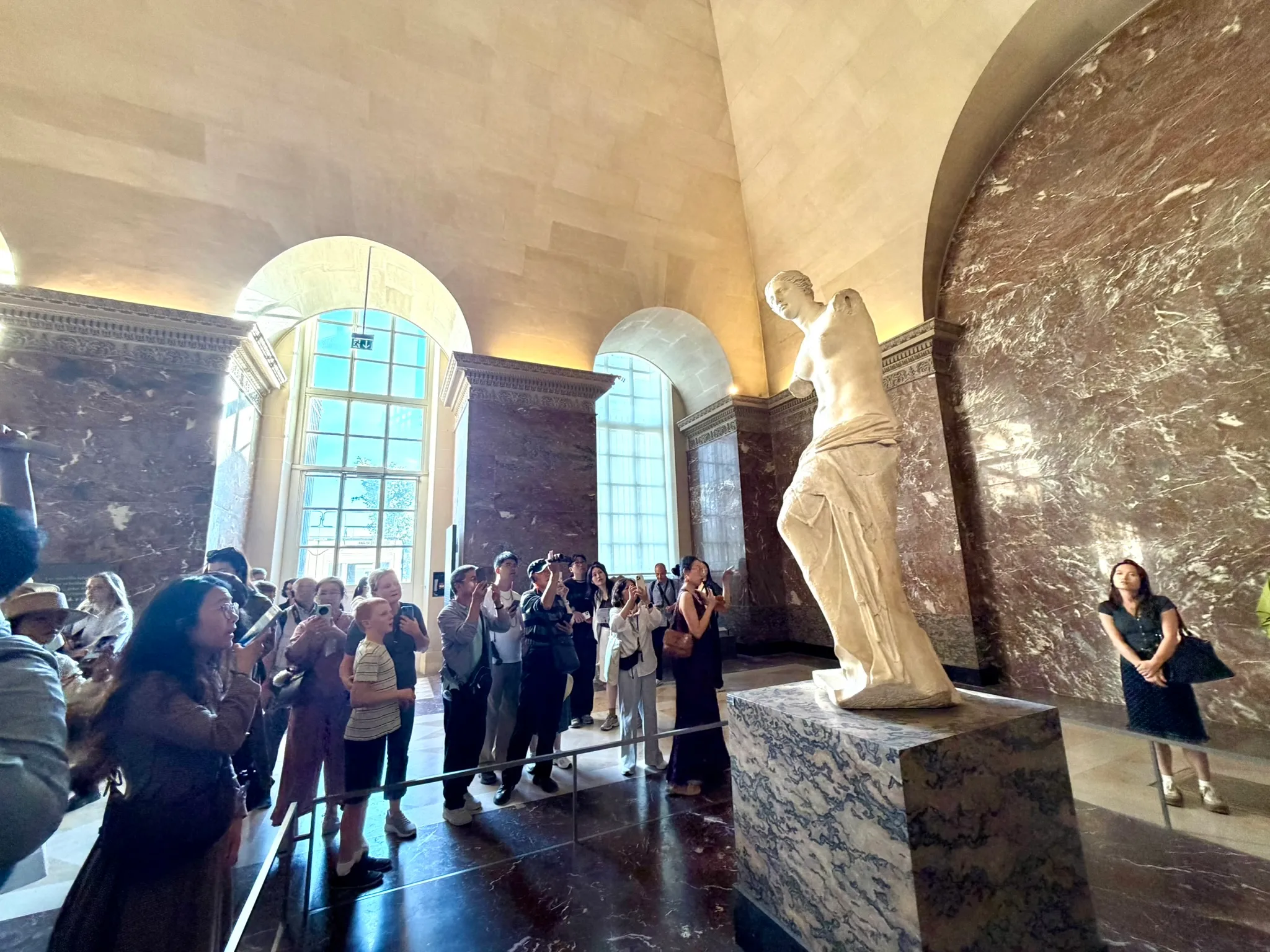 Visitors photographing the Venus de Milo in the Louvre's Greek Antiquities galleries