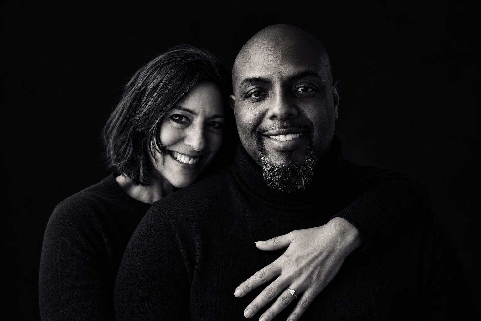 Black-and-white portrait of Allen and Angie Robinson smiling together.
