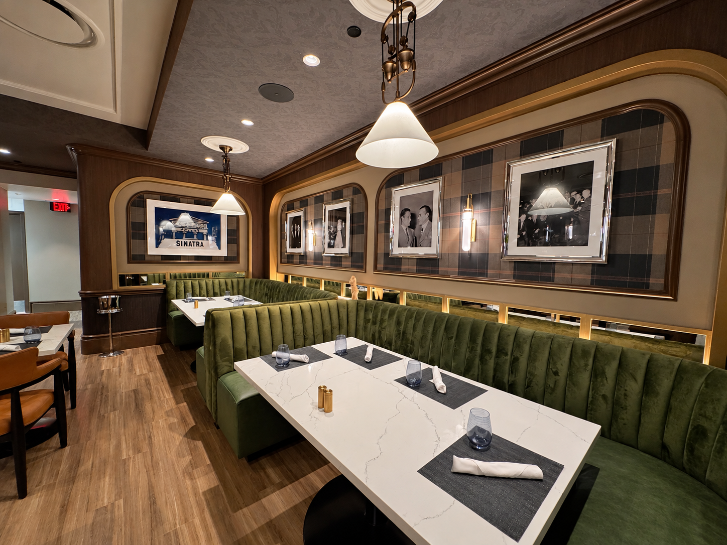 Green booths, pale marble tables and framed photographs at El Cortez. Photograph by Allen S. Robinson; enhanced with AI assistance.