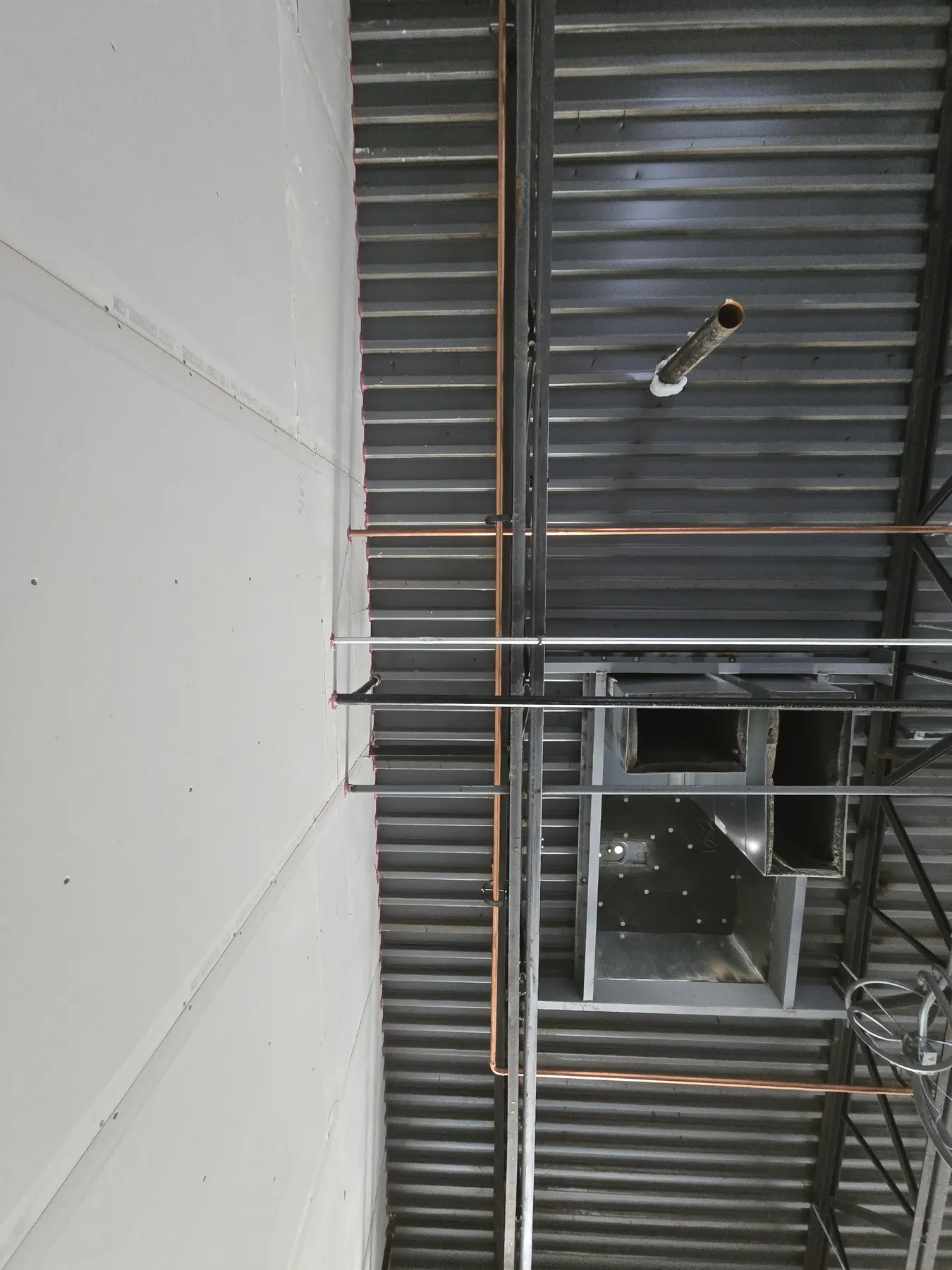 Commercial plumbing rough-in detail inside an Elizabethtown restaurant buildout.