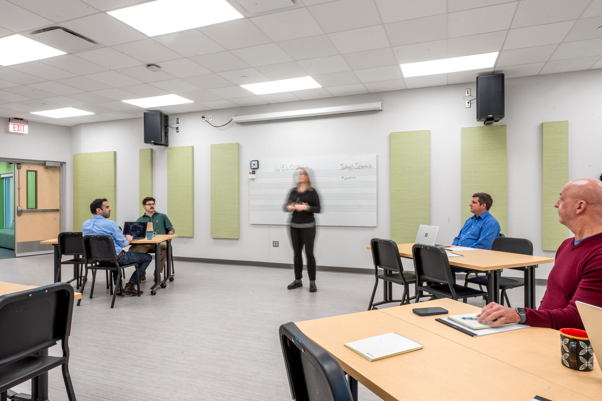 A facilitator leading a training session in a Studio
