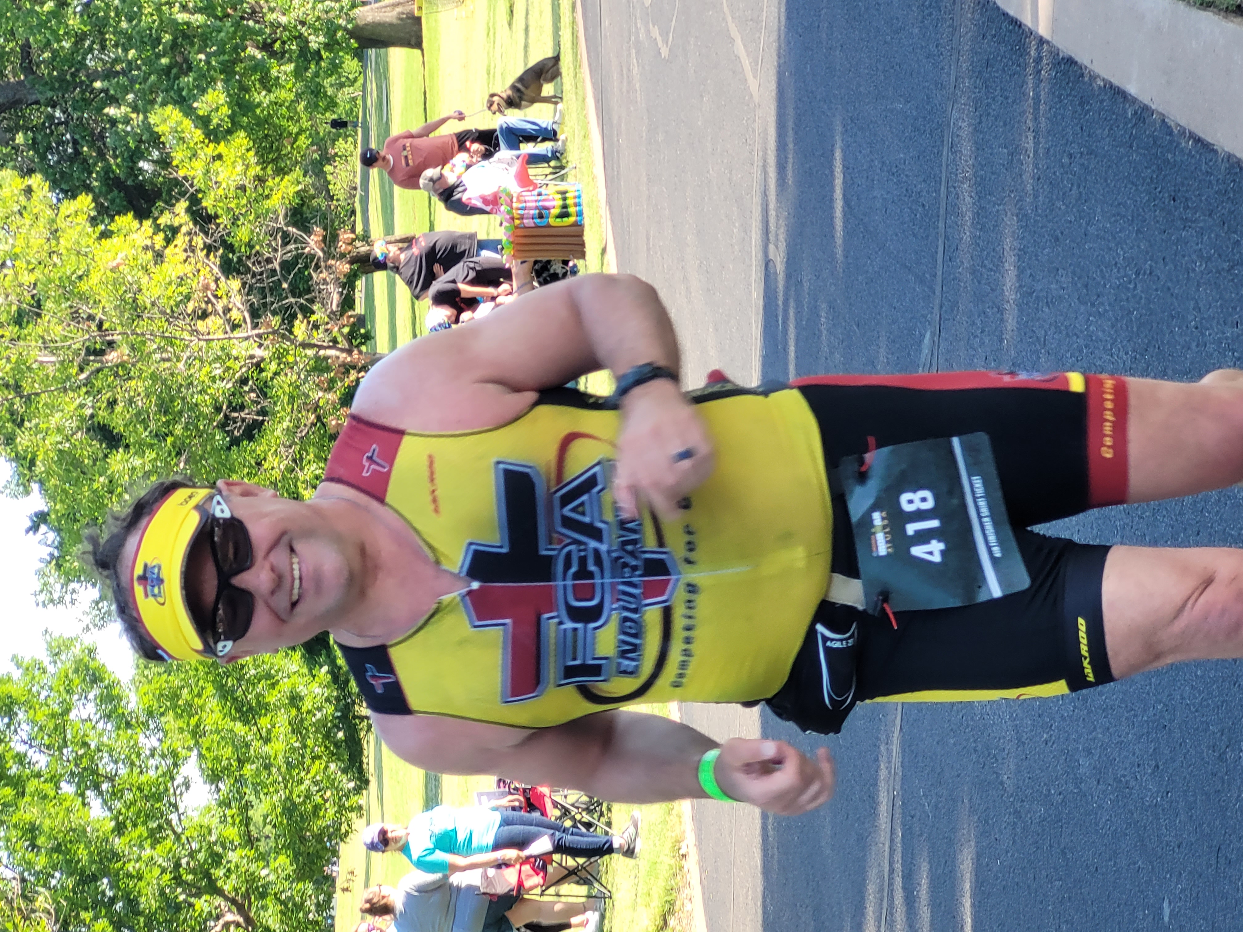Dave VanEpps smiling while running in a yellow FCA Endurance race outfit.