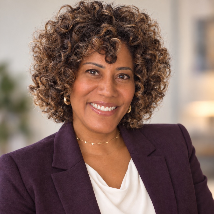 Gretchen G. Soto smiling in a plum blazer
