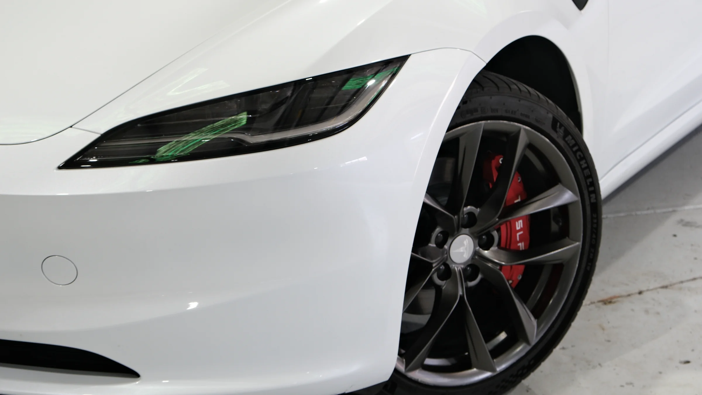 Front detail of a white Tesla Model 3 in the Safeway Auto showroom in West End, Brisbane