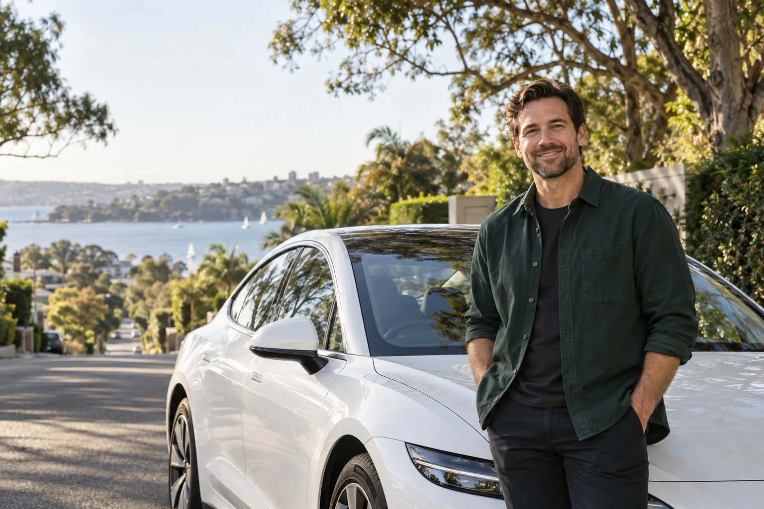Driver standing beside an electric sedan