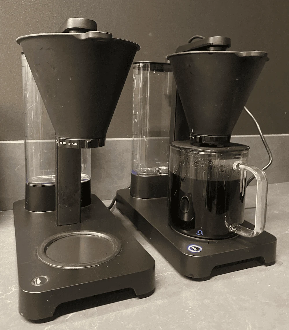 Two coffee machines, one missing a glass jug