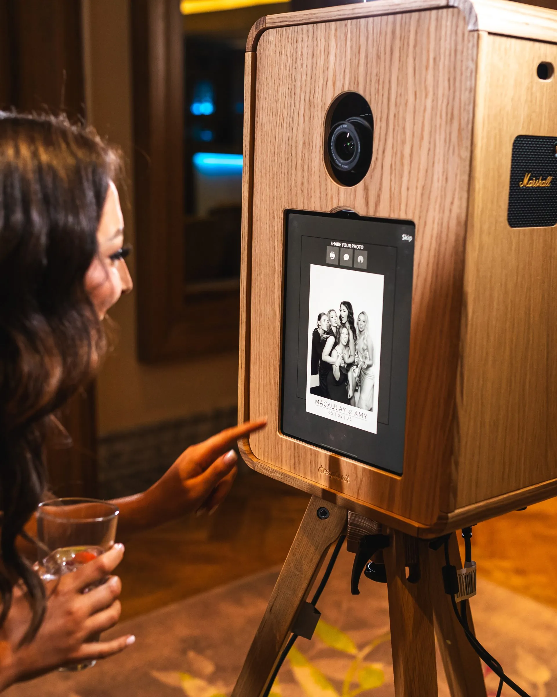 Close-up of the oak ICON photo booth with DSLR camera and print sharing screen
