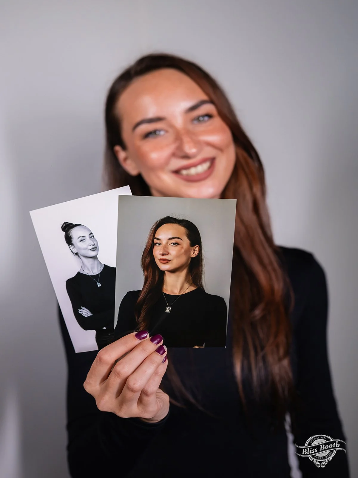 Guest holding her printed professional headshot at a corporate headshot booth