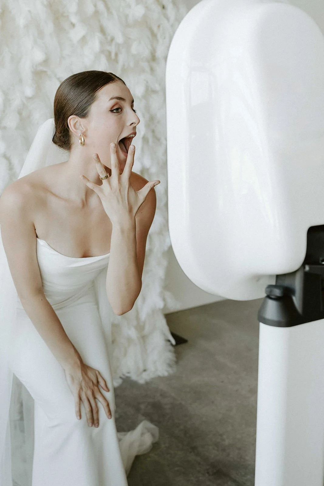 Bride reacting to her photo at the Halo booth