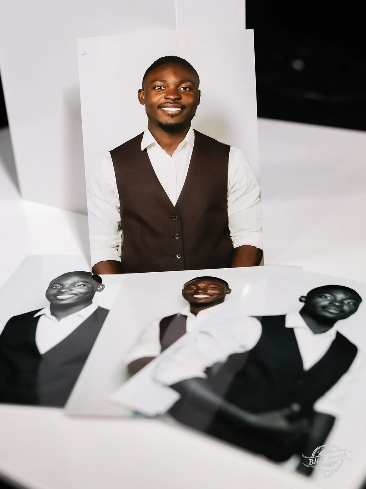 Set of printed headshots of a smiling guest