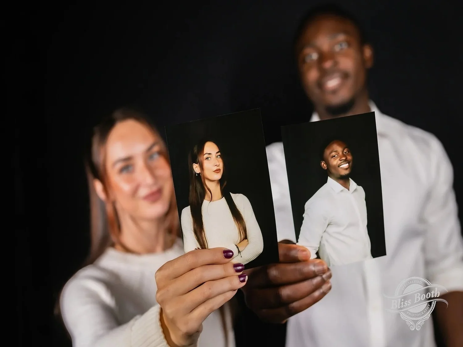 Guests showing printed headshots captured at a corporate event