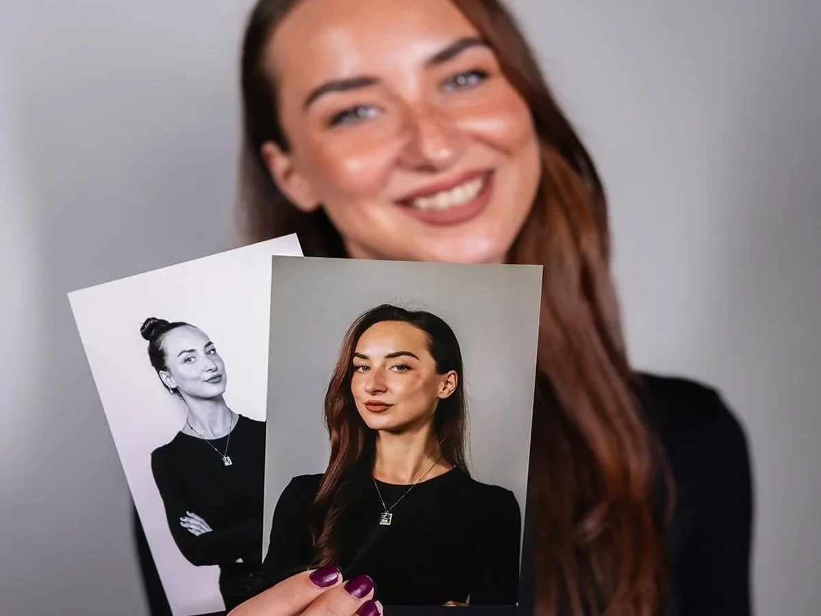 Guest holding printed headshots at a headshot booth