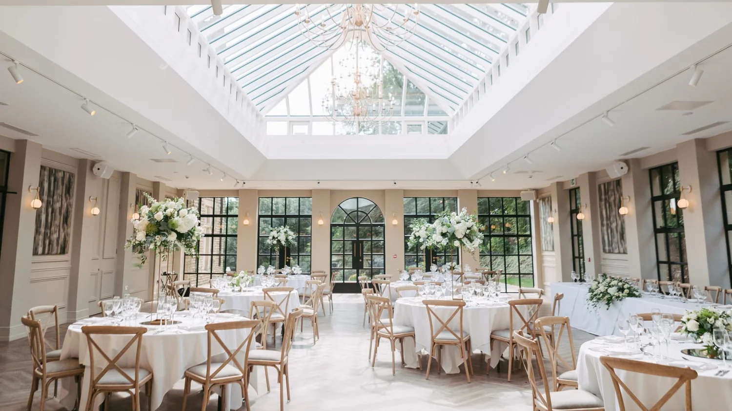 Wedding reception room under a glass roof at a venue near Leeds
