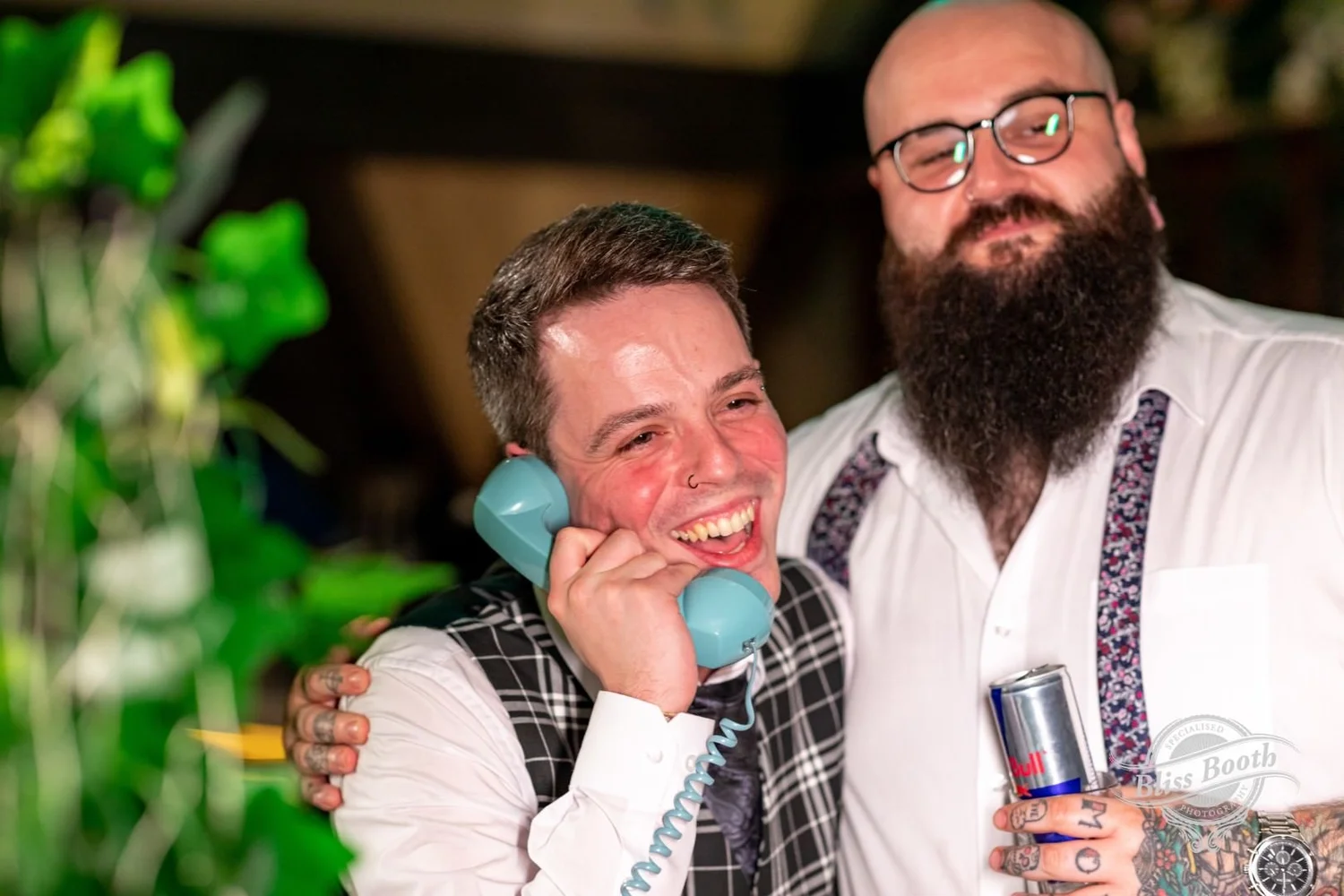 Groom and guest leaving a message on the audio guest book telephone