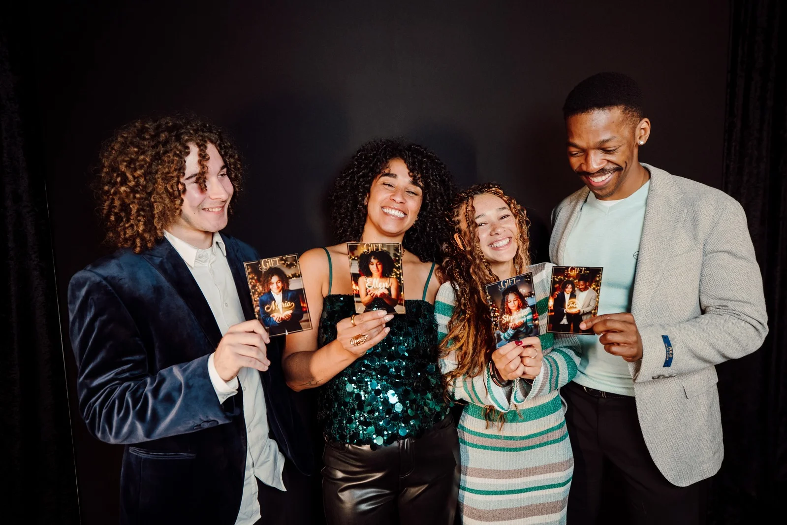 Group of friends with their festive photo booth prints