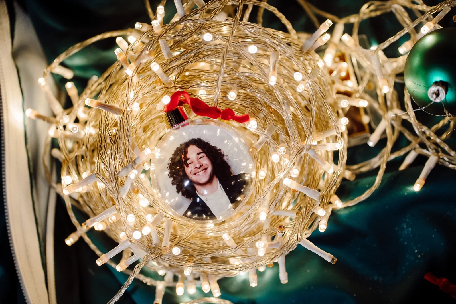 Personalised photo bauble nestled in a wreath of fairy lights
