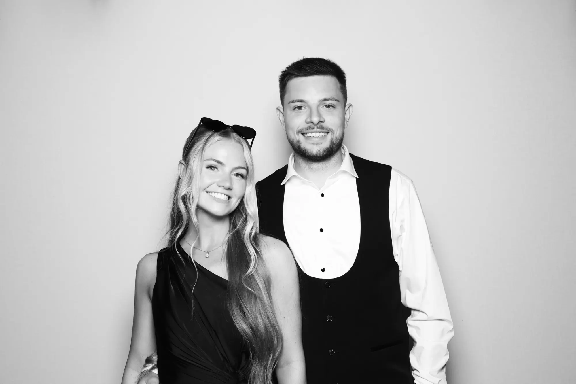 Black and white photo booth picture of a smiling couple at a wedding