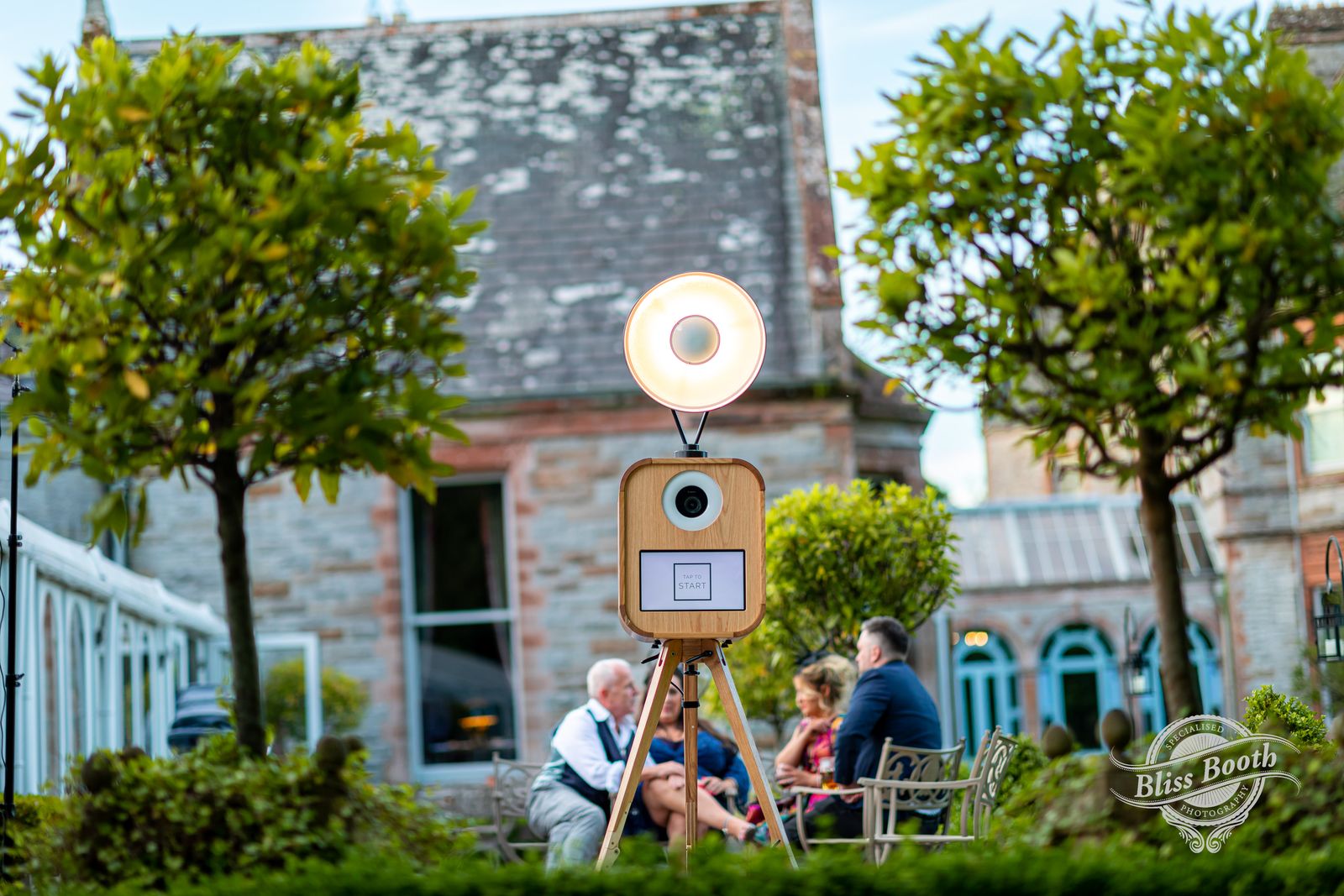Oak Retro photo booth on a wooden tripod in a manor house garden at a summer wedding