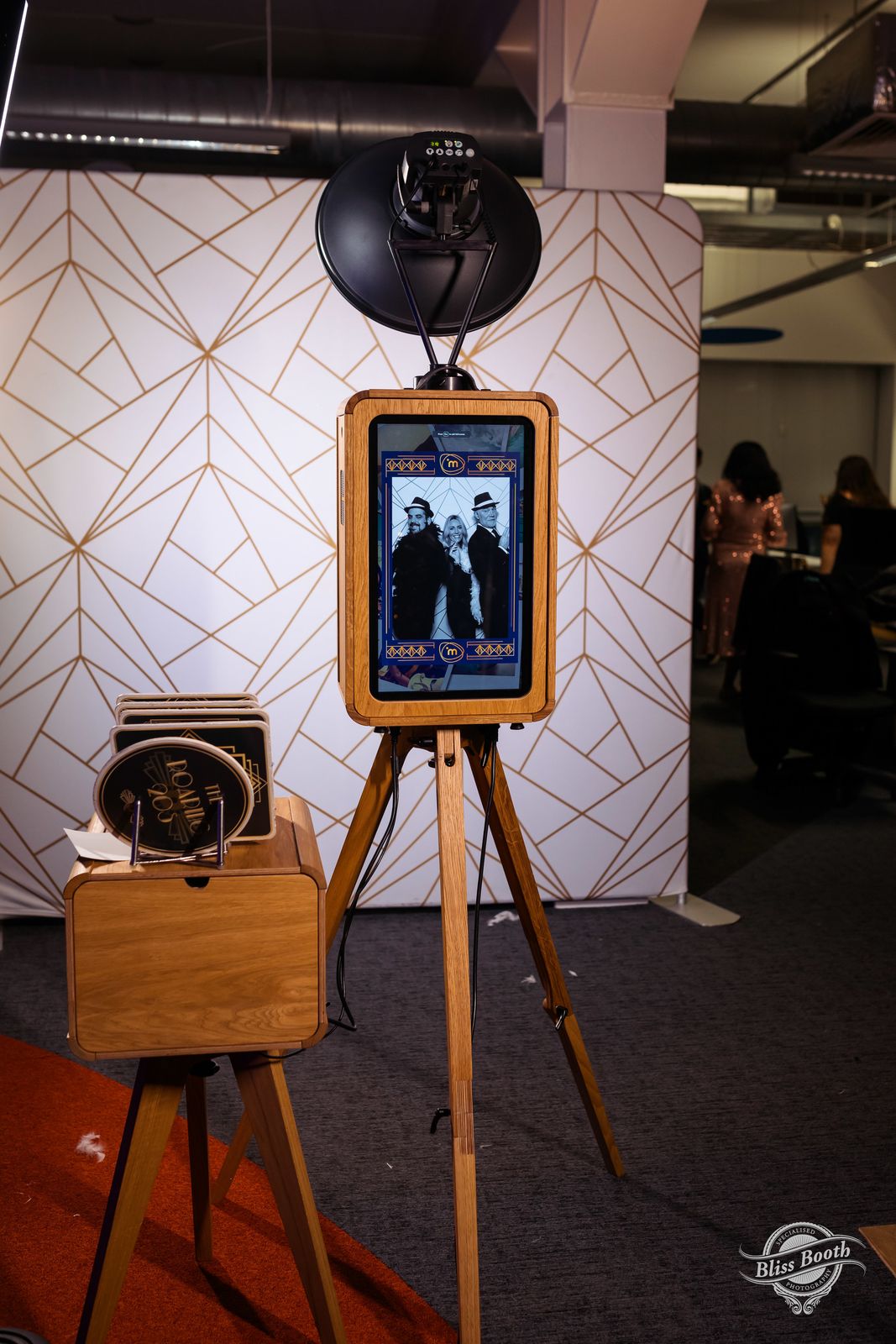 ICON photo booth set up in front of a gold geometric backdrop