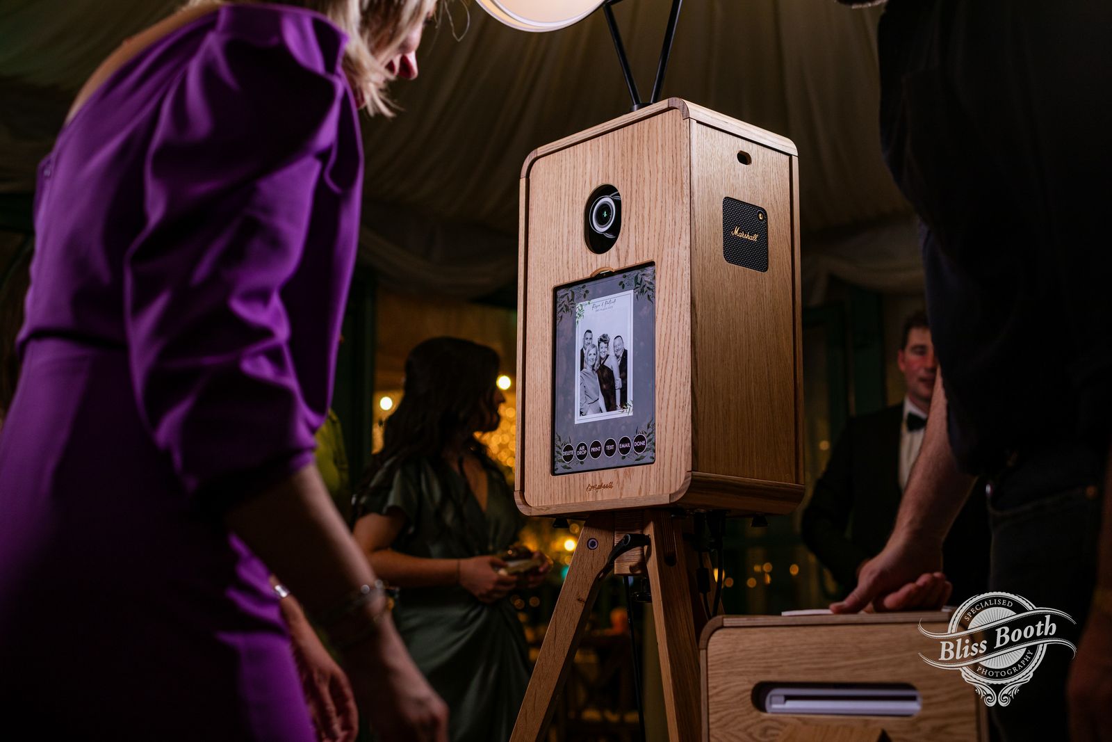 Guests using the ICON photo booth and print station at night