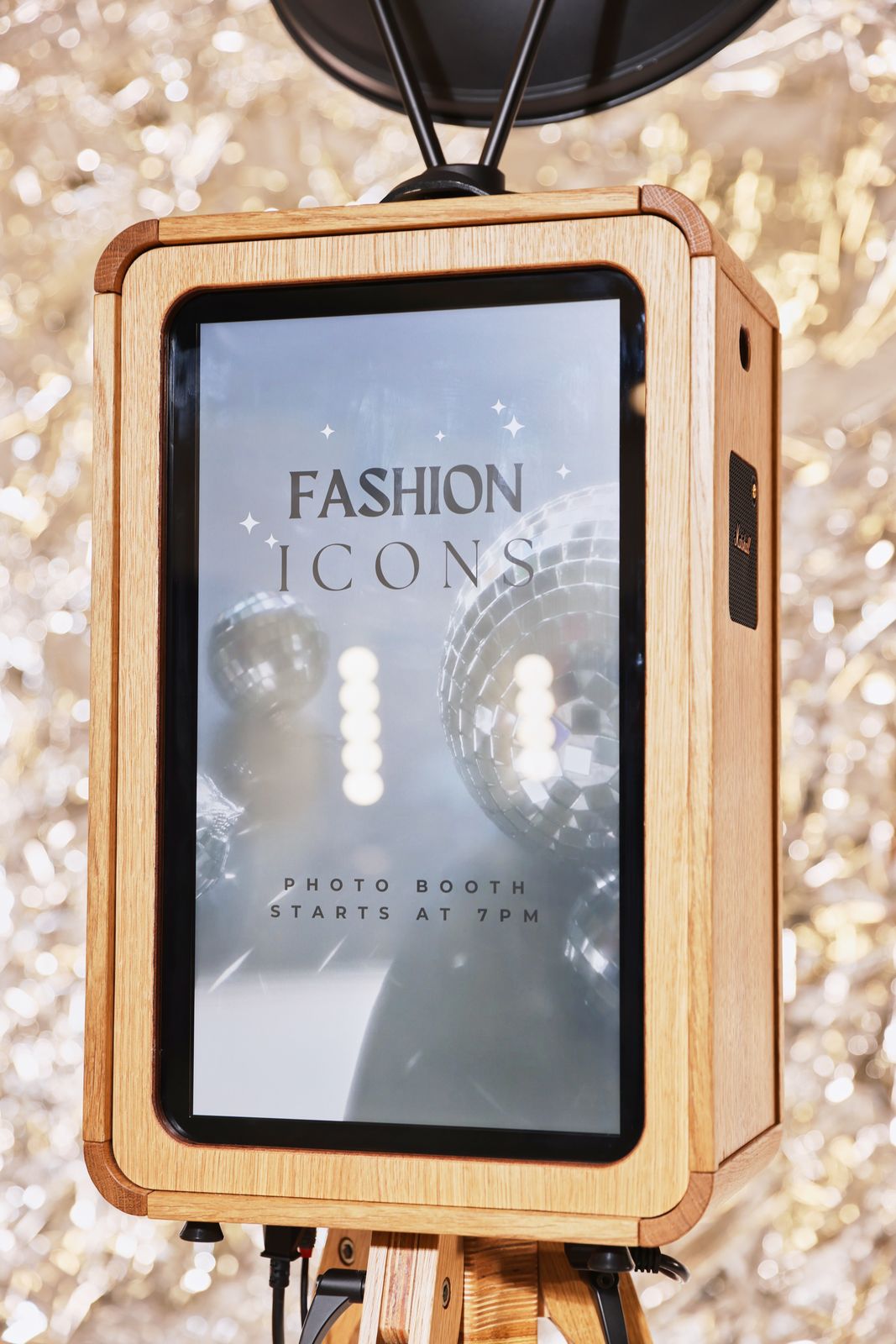 Oak ICON photo booth screen against a silver tinsel backdrop