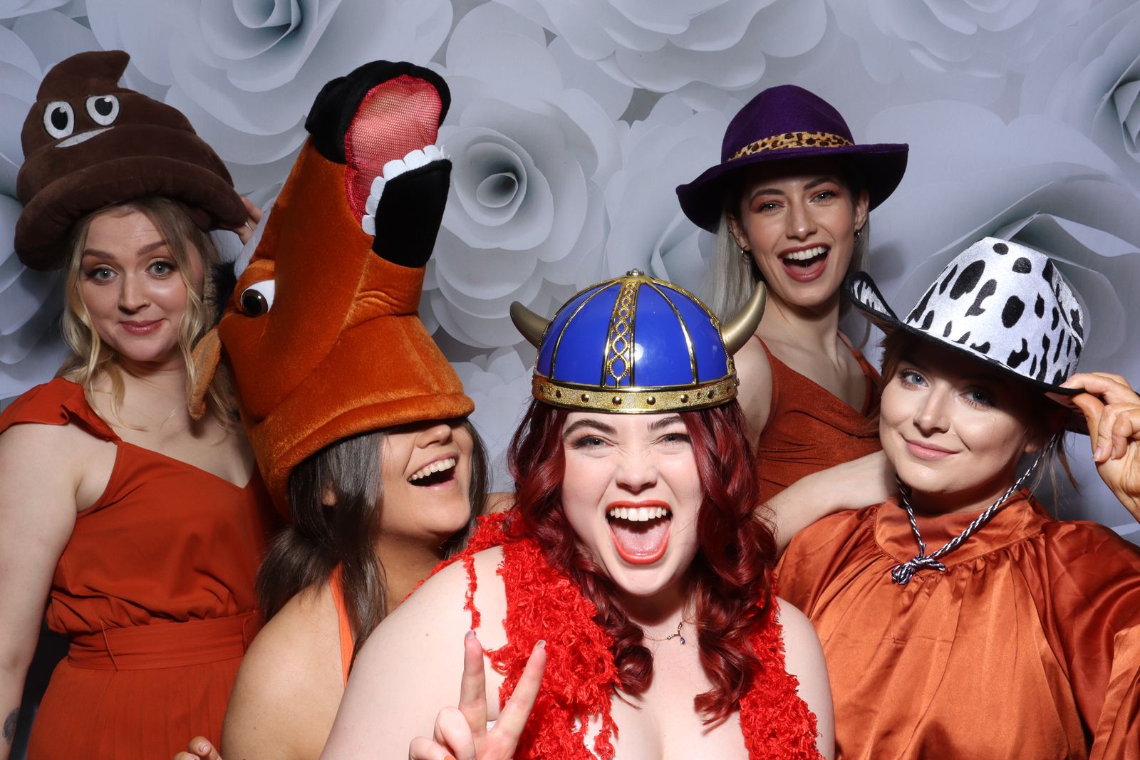 Bridal party in fun hats and feather boas posing in the Retro photo booth