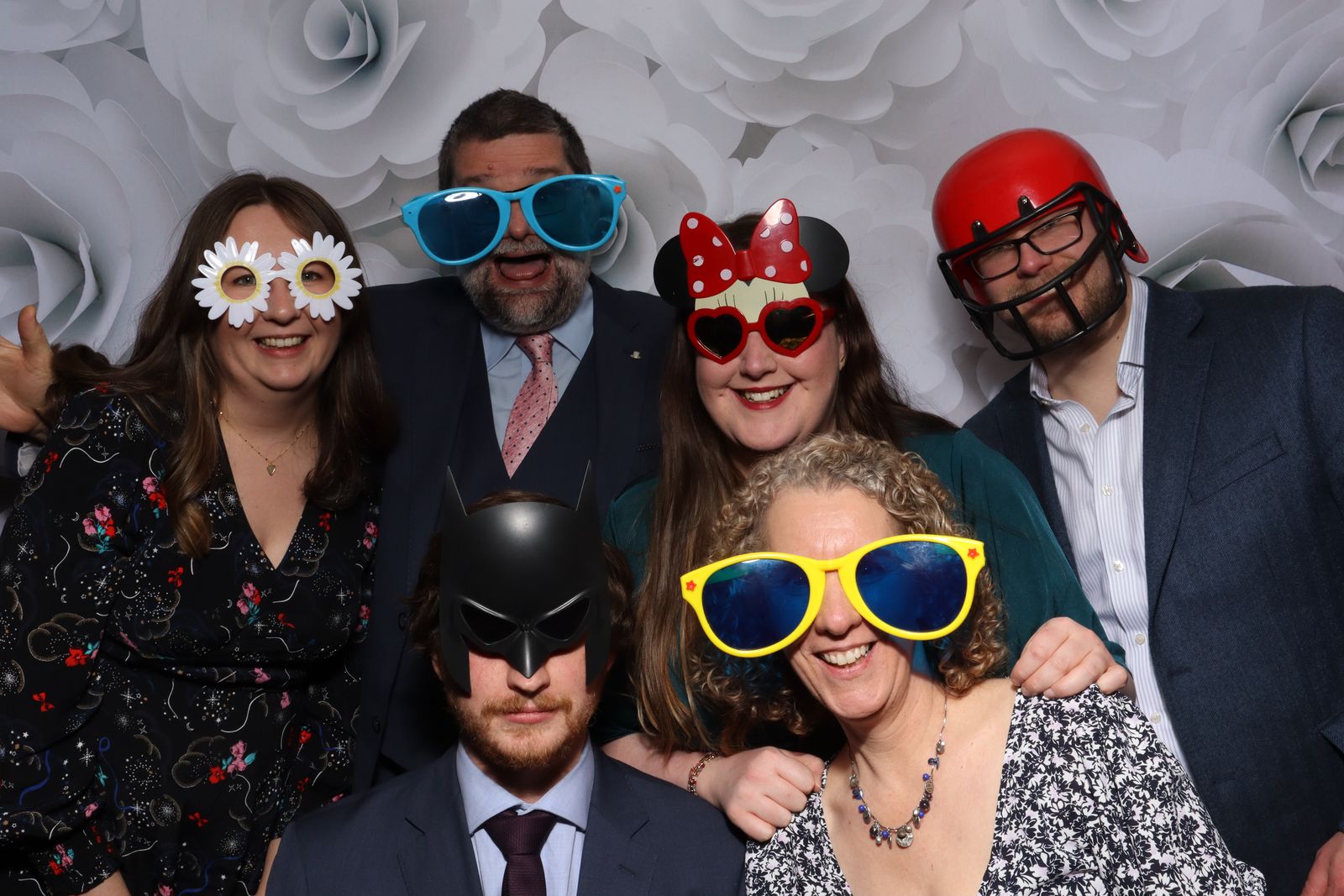 Wedding guests in fun glasses and hats posing in the Retro photo booth