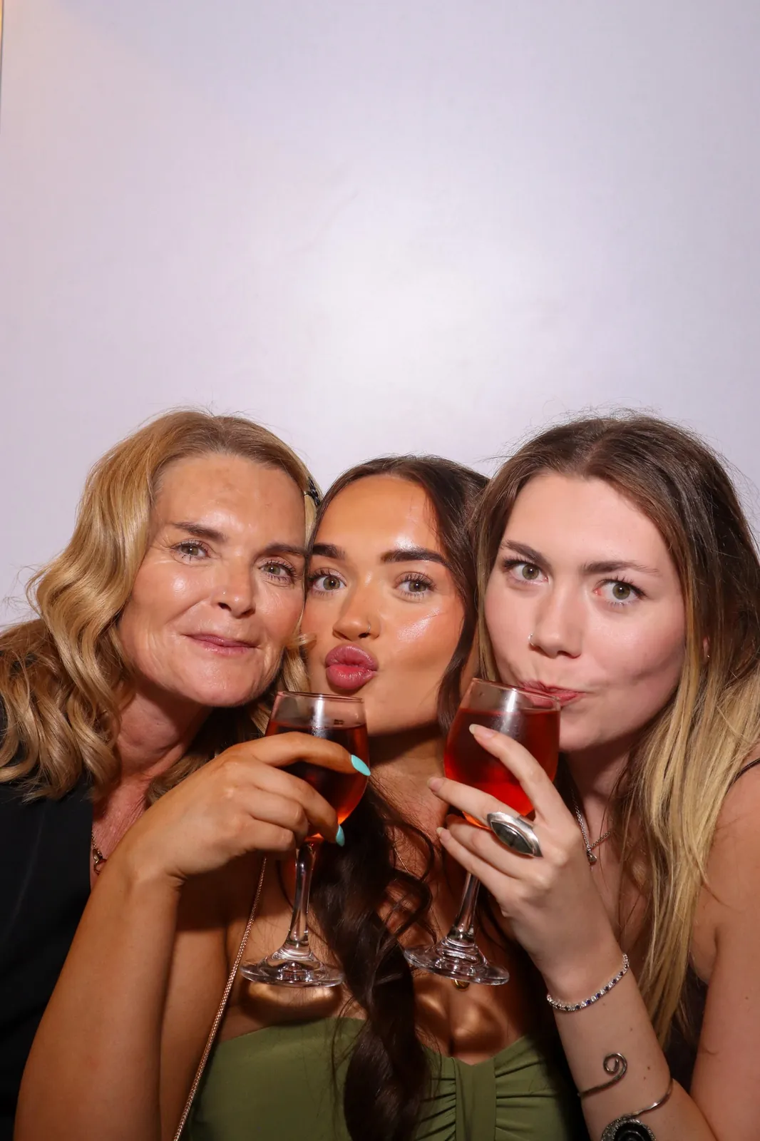 Three guests with drinks in the Photomatic photo booth
