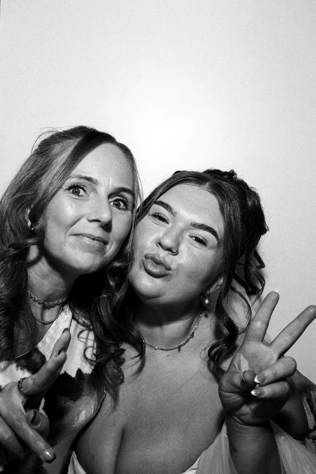 Bride and her mum posing in the Photomatic photo booth, black and white