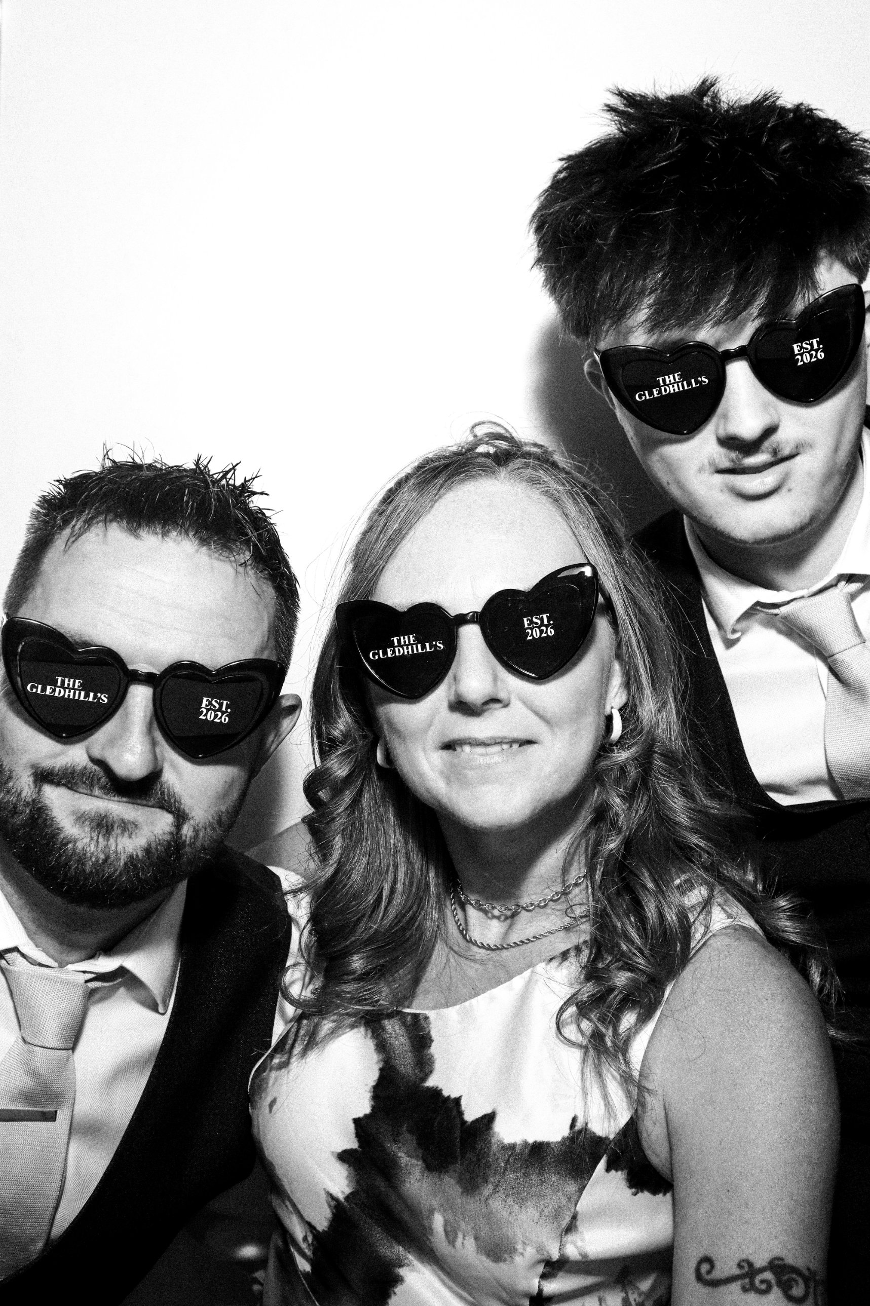 Three wedding guests in personalised heart sunglasses at The Manor Rooms