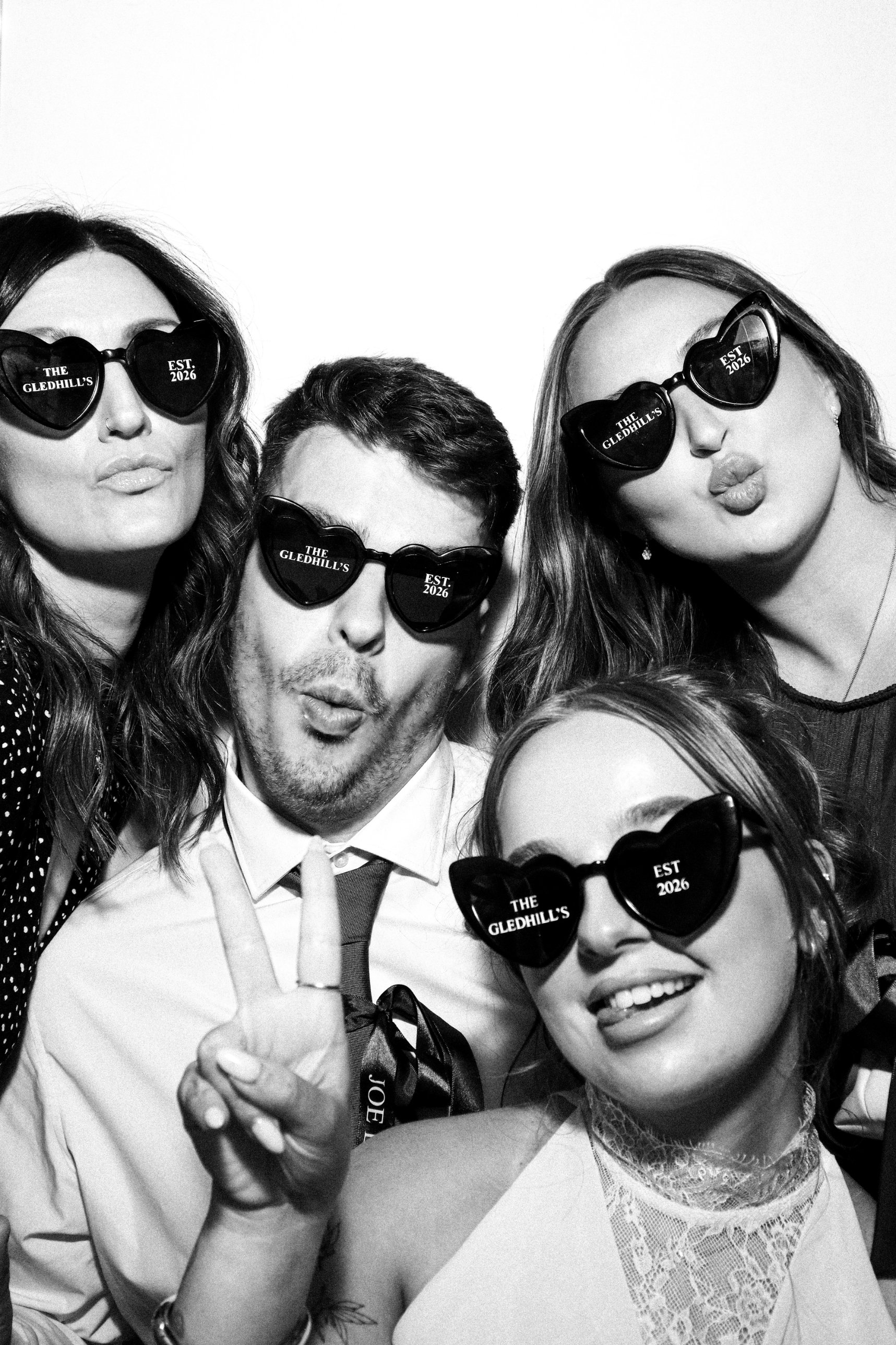 Wedding guests in personalised Gledhill heart sunglasses in the Photomatic