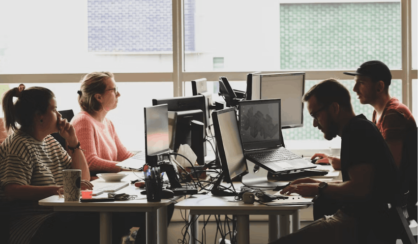 Four professionals discussing quarterly workforce trends and macro talent intelligence