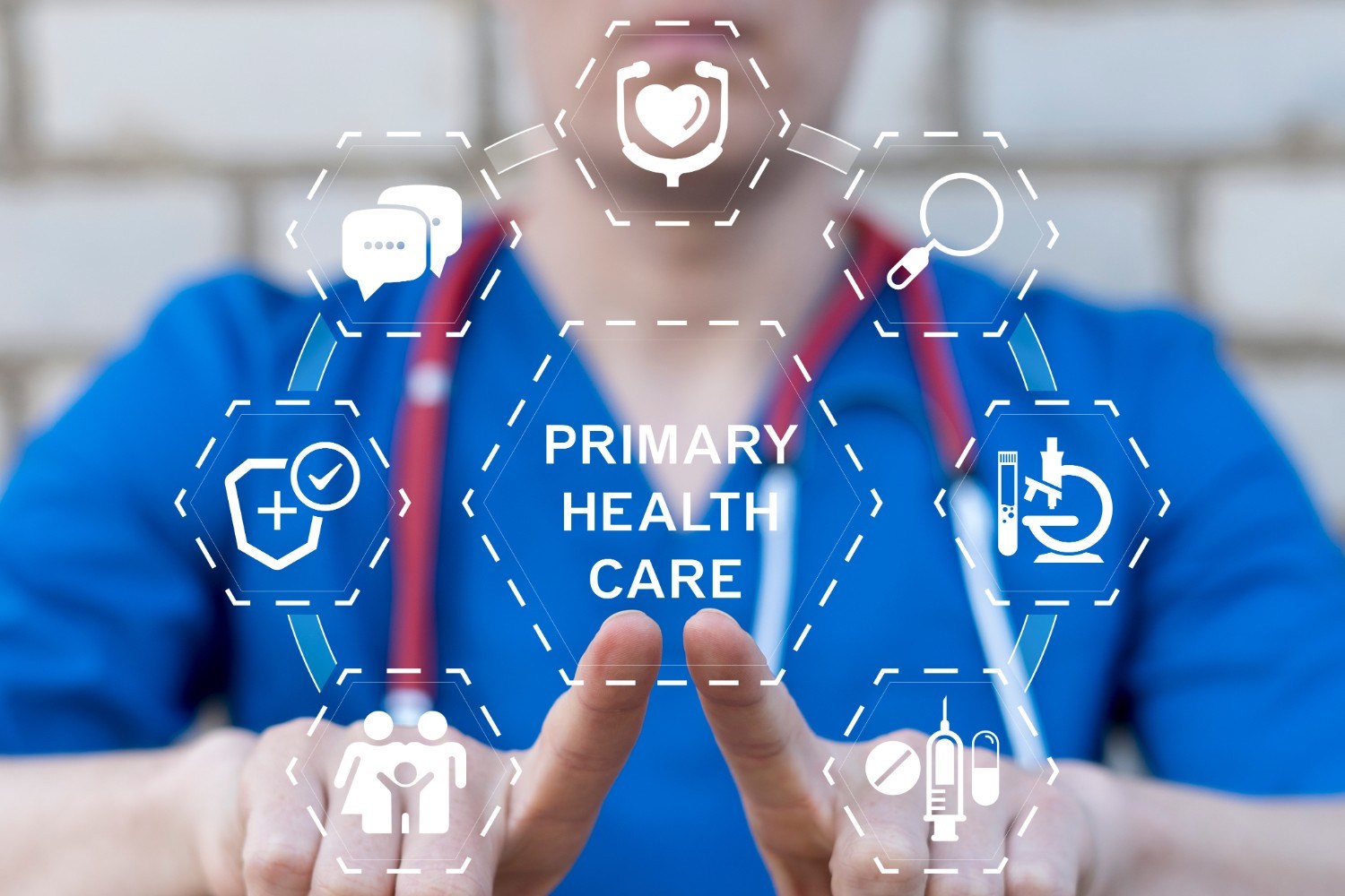 A healthcare professional in blue scrubs with a red stethoscope points at hexagonal icons surrounding the words 'PRIMARY HEALTH CARE,' representing healthcare services including heart health, communication, research, family care, and medication.