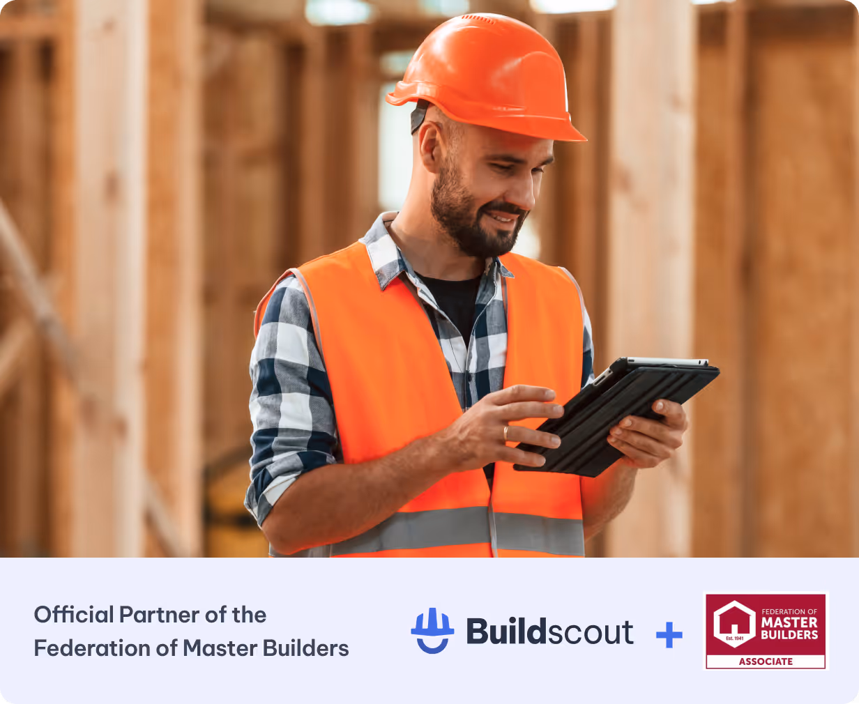 Construction worker using a tablet on a timber-frame building site