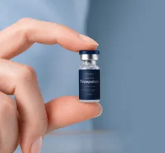 Hand holding a single vial