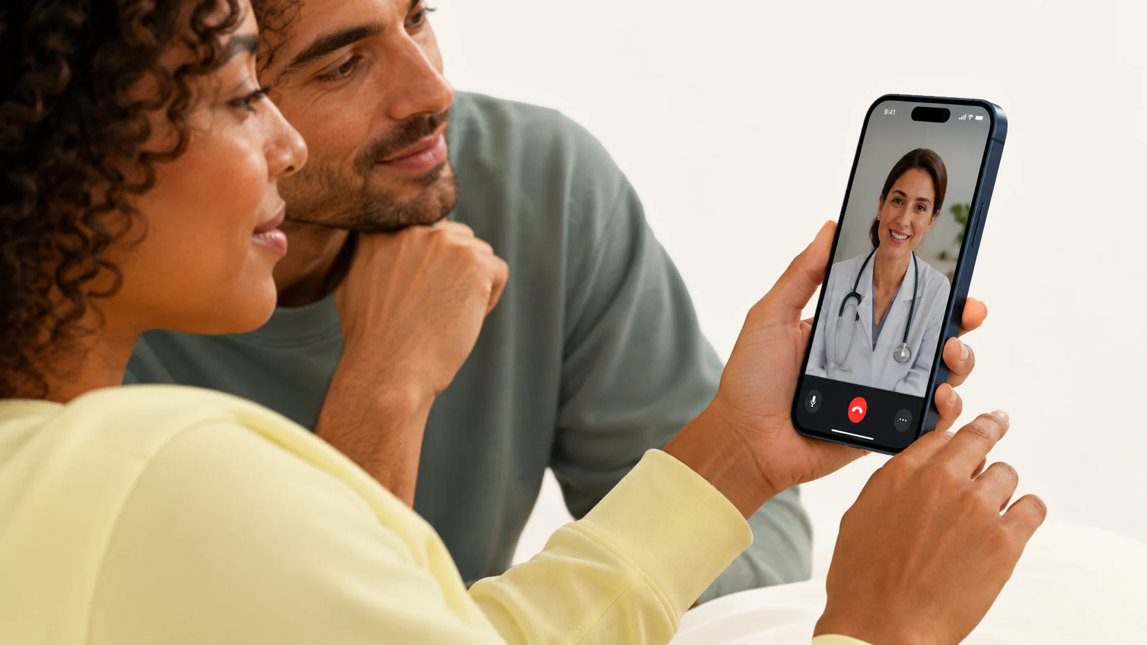 Couple on a video consultation with a licensed provider on a smartphone