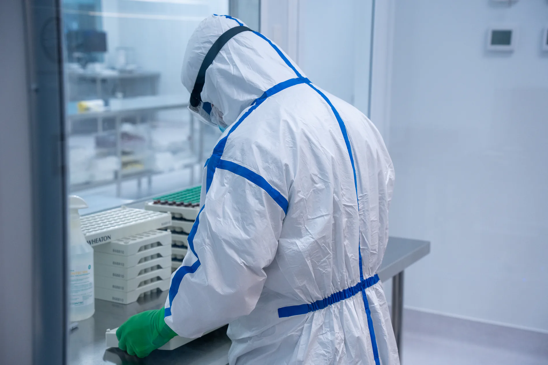 Pharmacist in sterile cleanroom gear compounding medication at Evoluciona Pharma